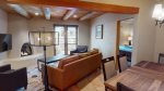 Open concept living and dinning room with southwestern beamed ceilings